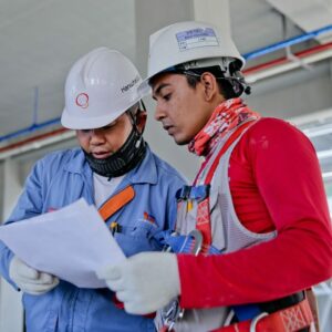 Two industry workers reviewing OSHA recordkeeping requirements.