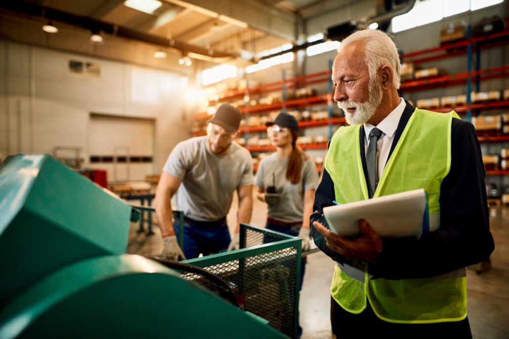 Old man inspecting a machine