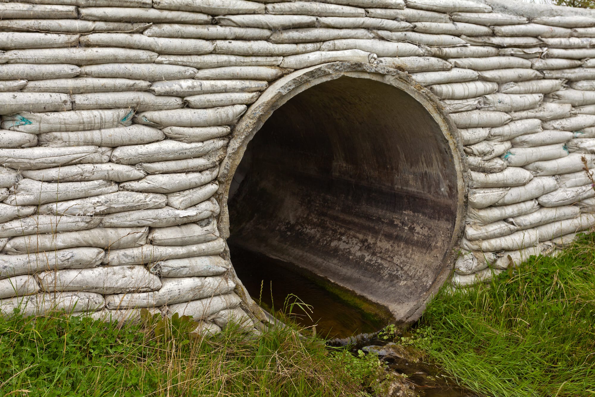 A storm drain with water running out of it