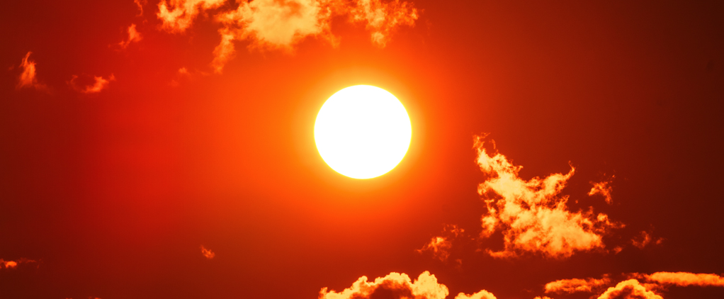 Orange sun in sky