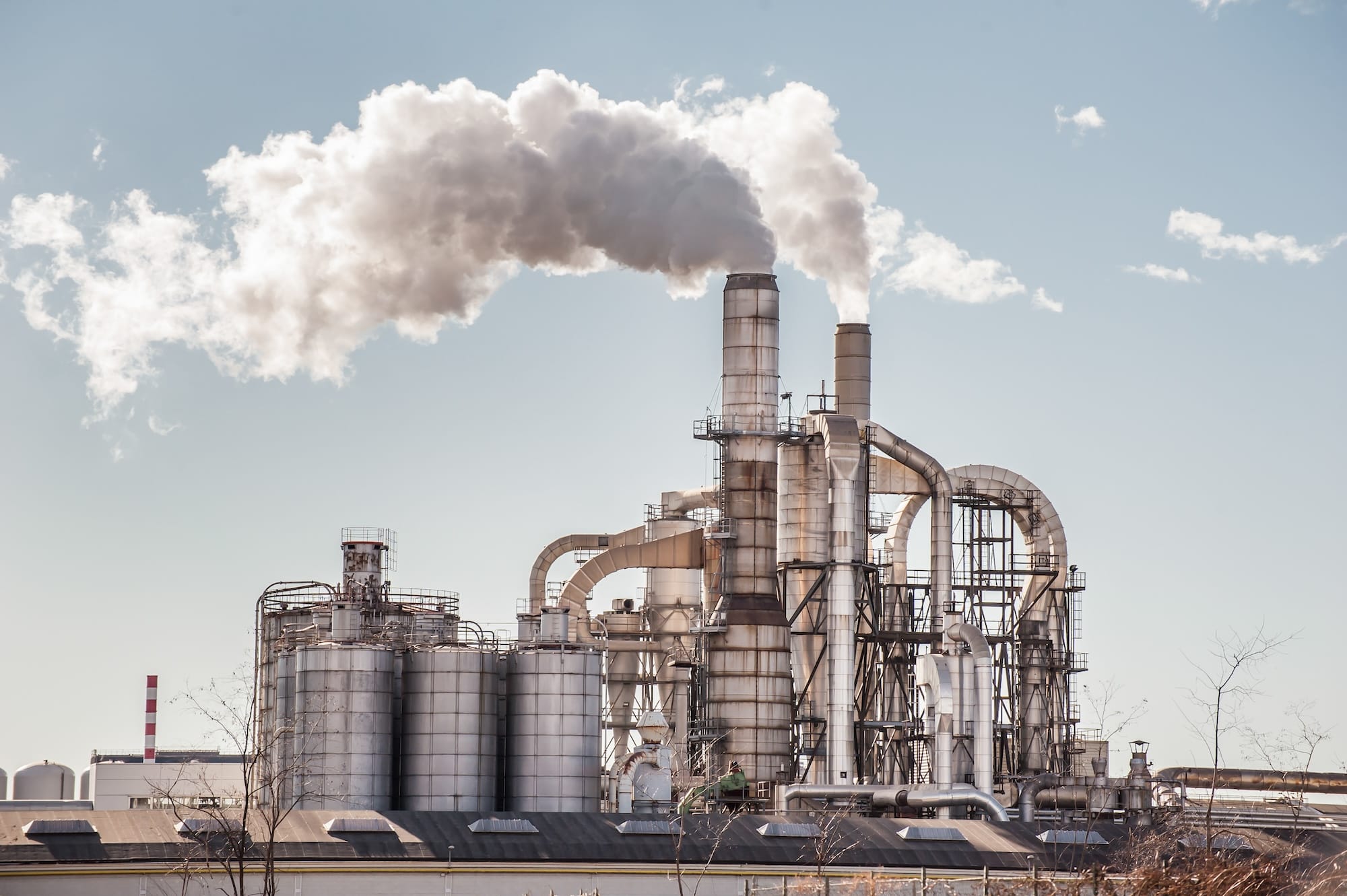 Industrial facility with smoke in the sky