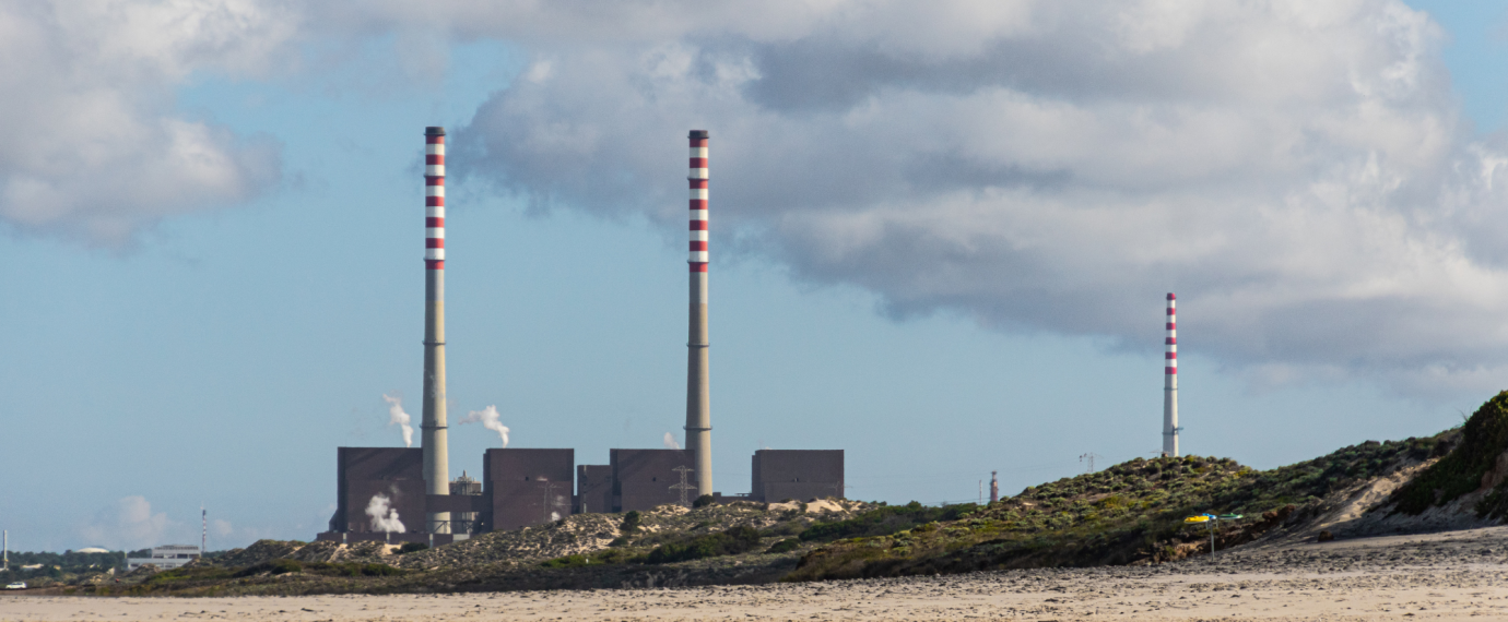 Factory with smoke stacks on the beach