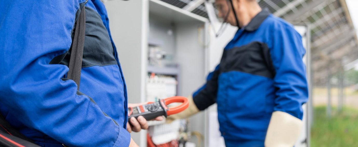 Two factory workers with electrical safety equipment