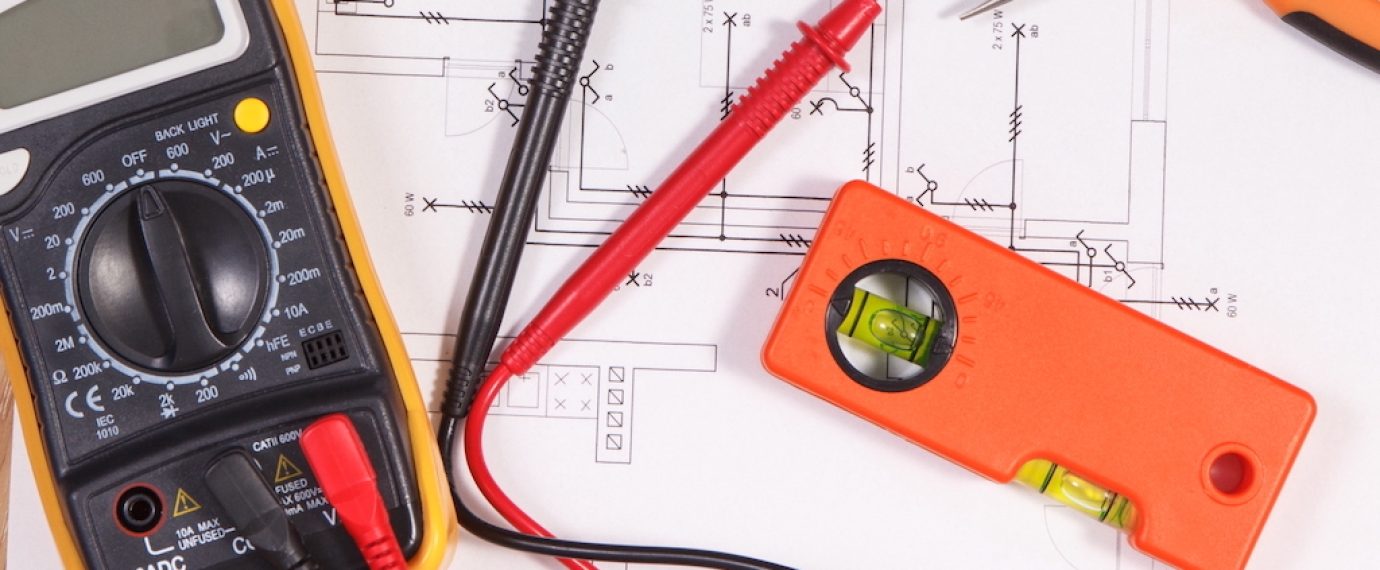 Electrical construction blueprint or diagrams, multimeter for measurement in electrical installation and accessories for engineer jobs