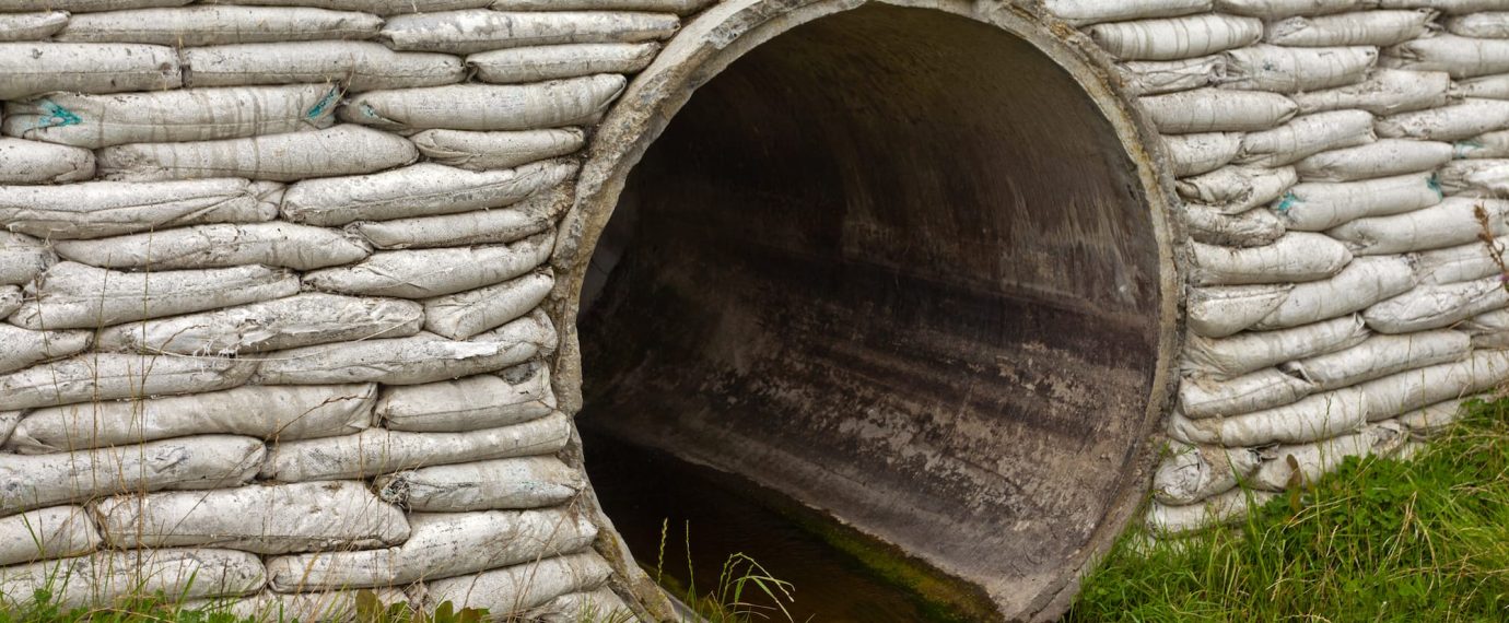 A storm drain with water running out of it