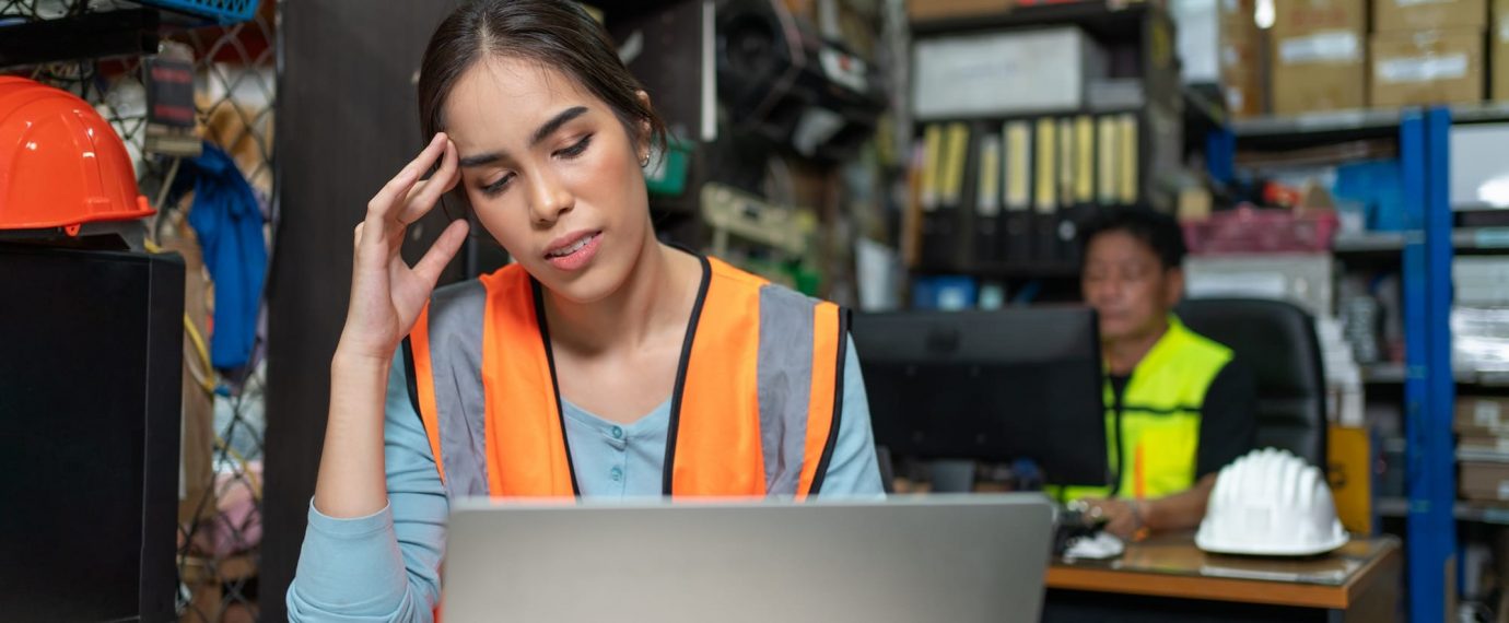 Woman with safety vest in front of laptop
